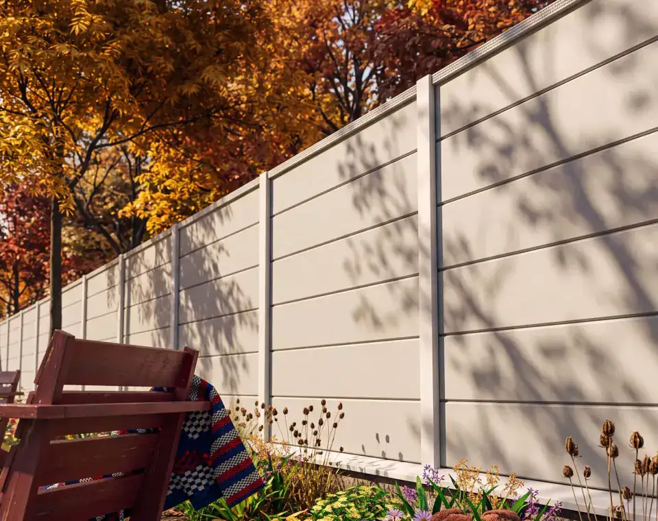 Concrete fence with smooth panels in a yard