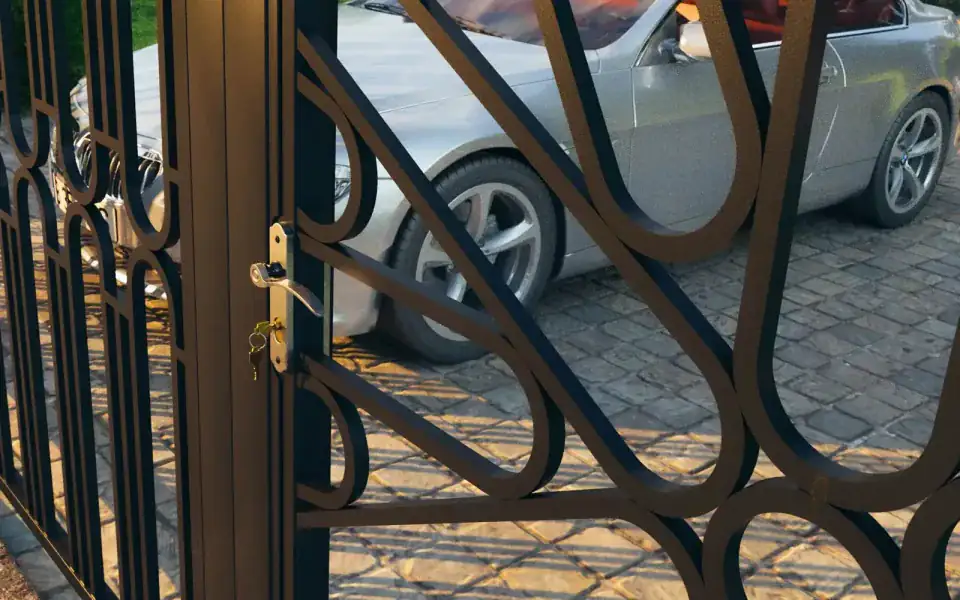 Metal gate with decorative elements — detail of the handle and lock