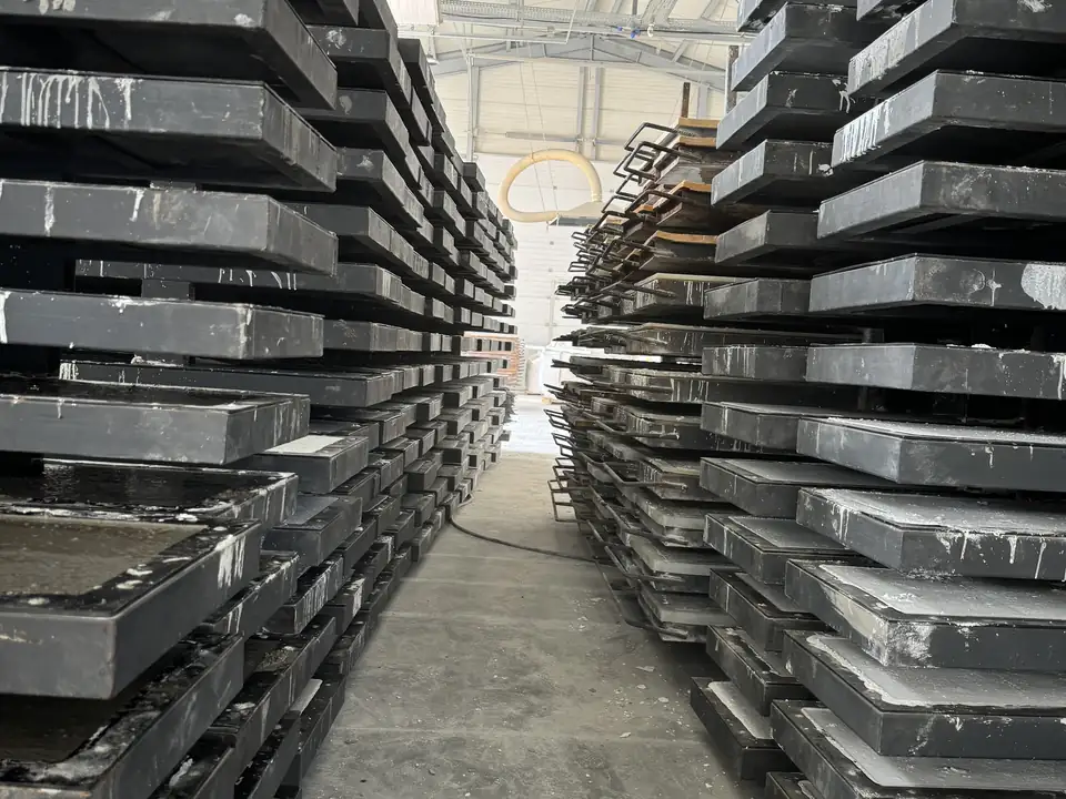 Stacks of steel panel moulds in the production hall