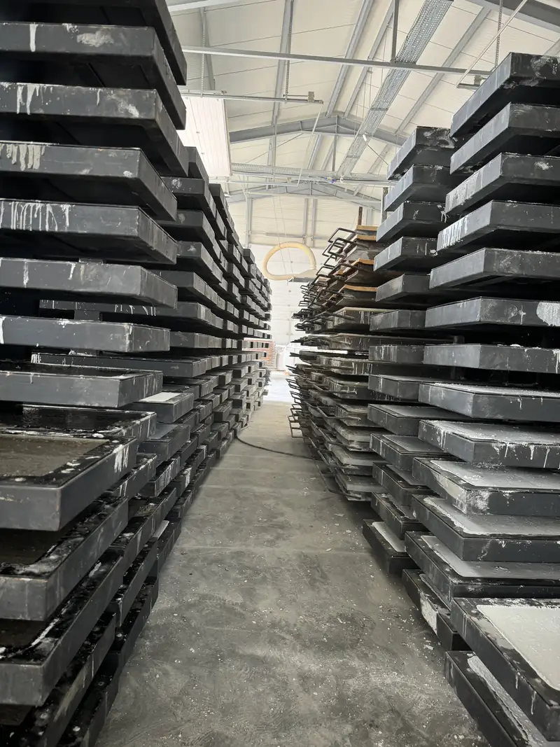 Stacks of steel panel moulds in the production hall