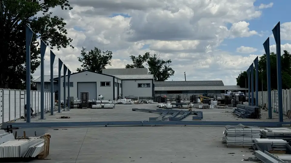 The third production hall under construction — the steel structure in the yard