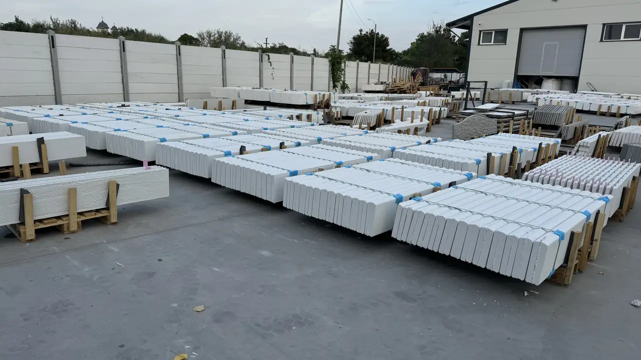 Rows of pallets with white concrete panels in the factory yard