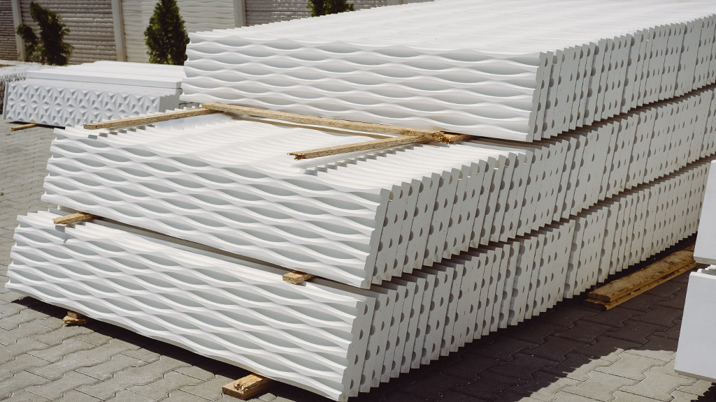 White concrete fence panels stacked on top of each other in the factory yard